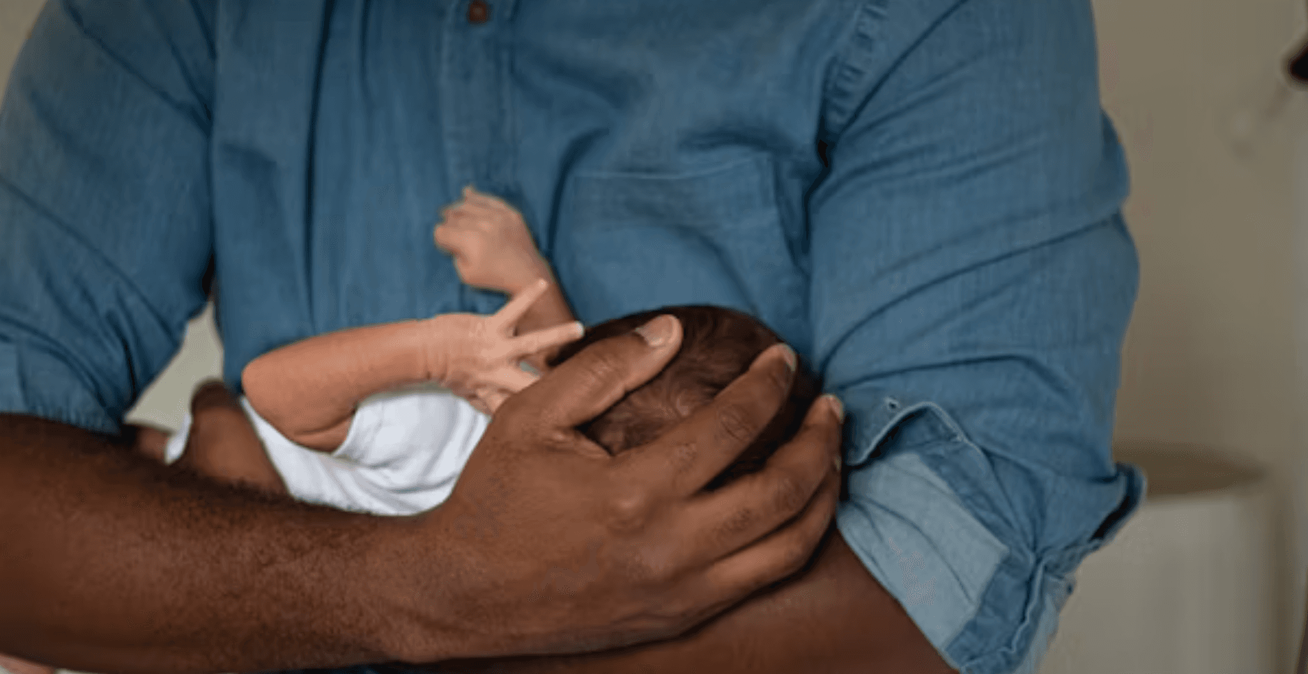 Father holding baby's hand
